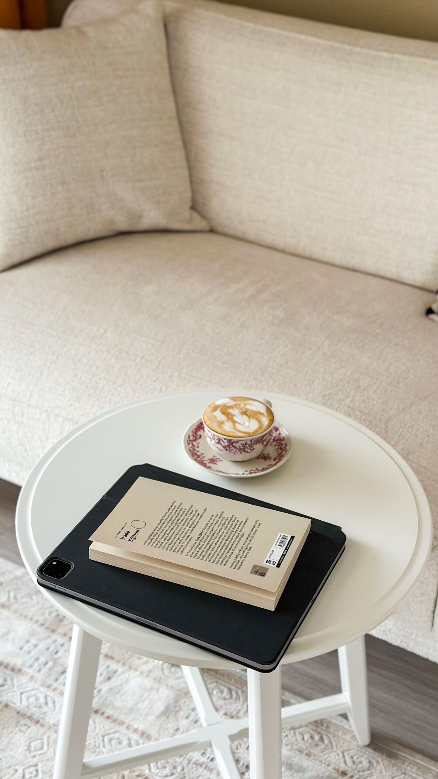 Linen sofa with a book and tea on a small side table