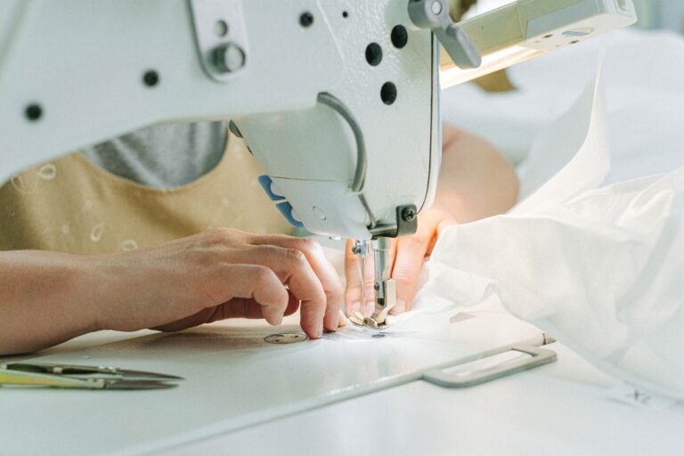 Sewing machine stitching white fabric