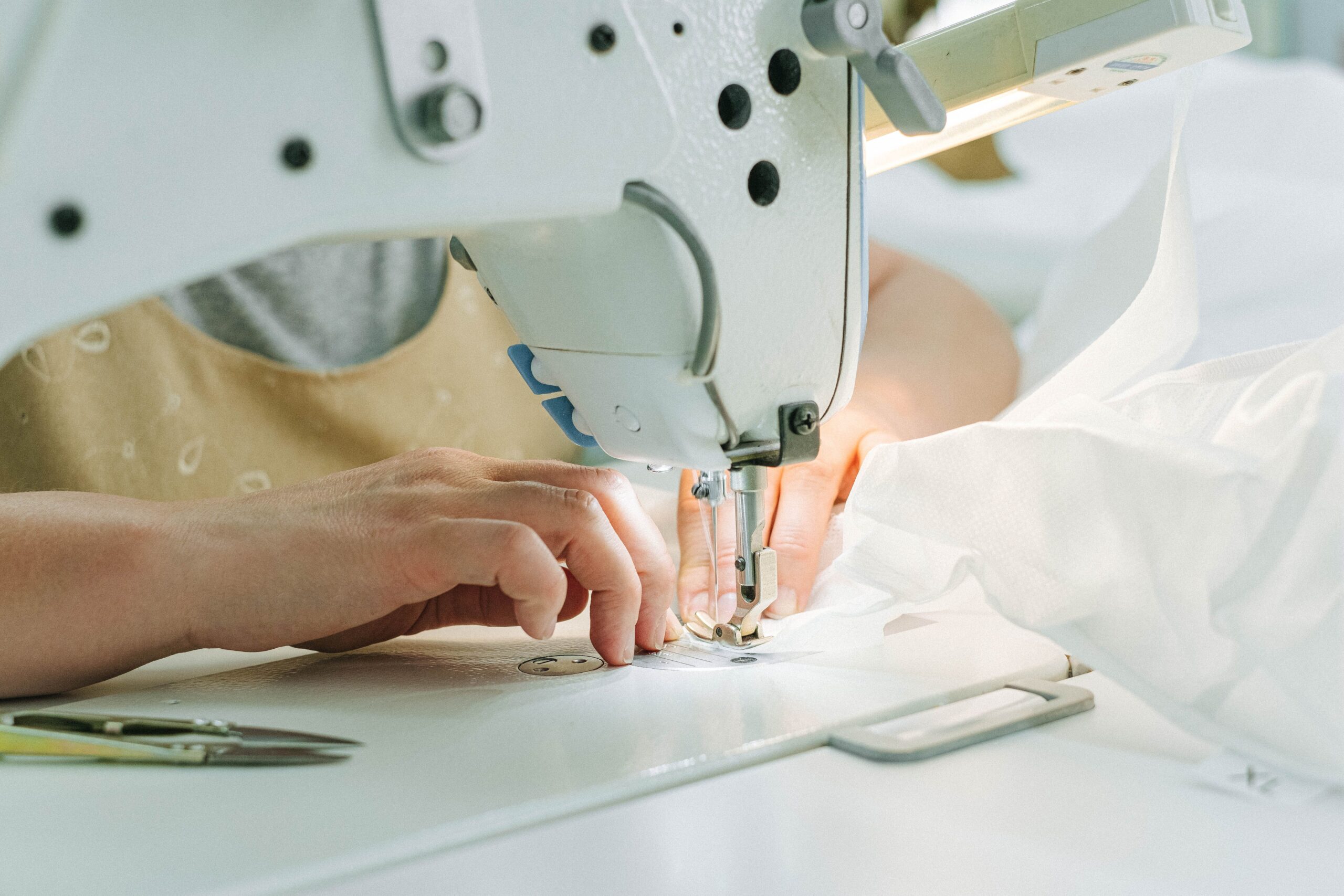 Sewing machine stitching white fabric