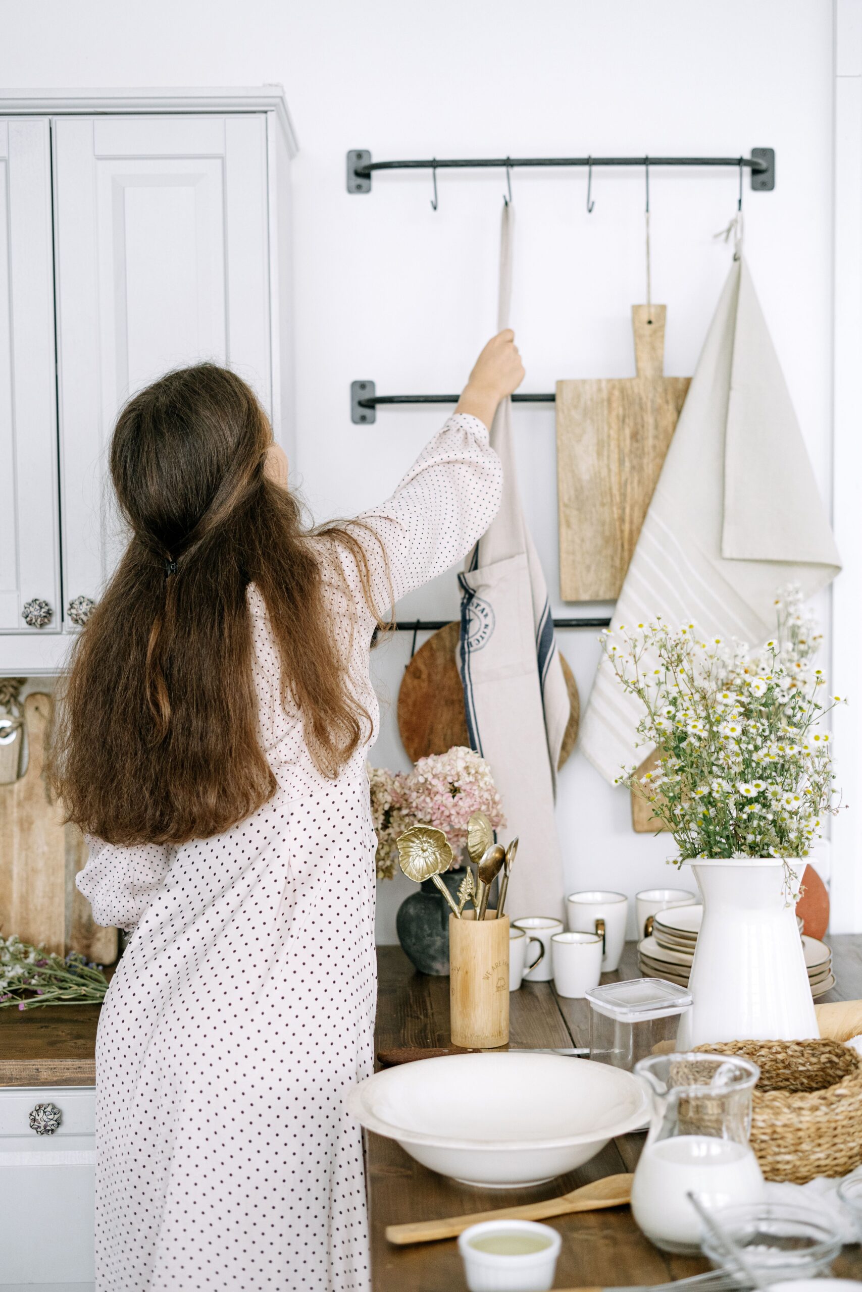 Woman arranging her small bright kitchen
