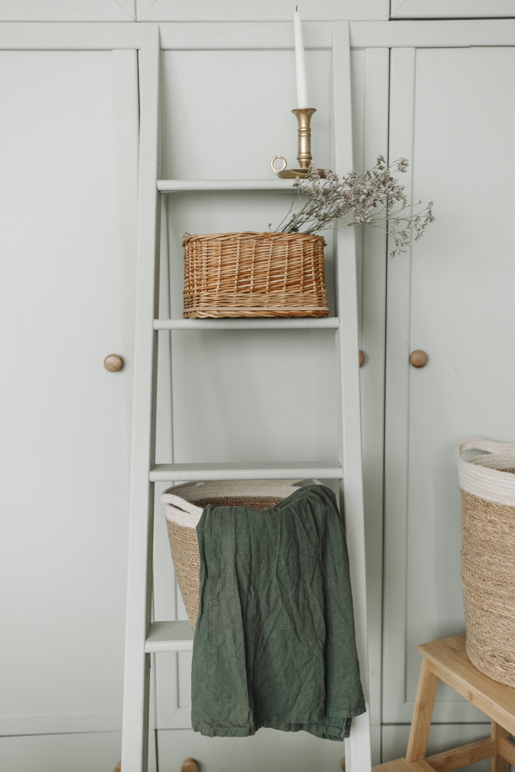 Ladder shelf with a basket and linen
